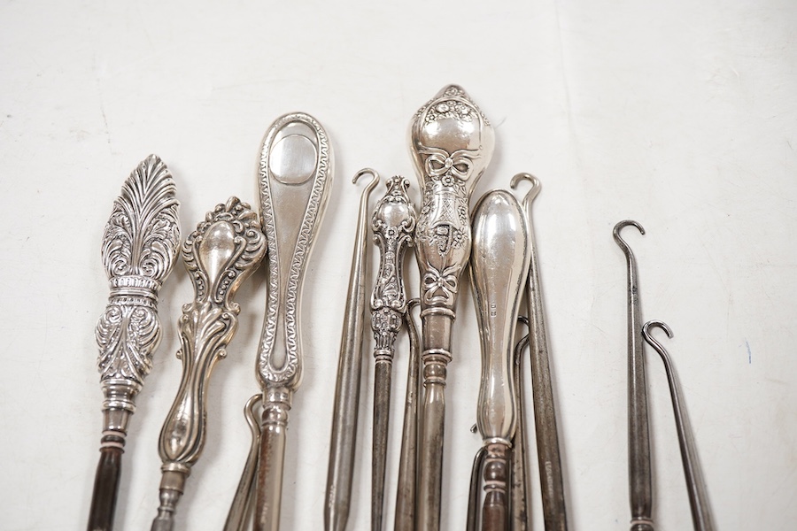 A collection of fourteen assorted late 19th/early 20th century silver handled button hooks, including tortoiseshell pique, longest 24.4cm.